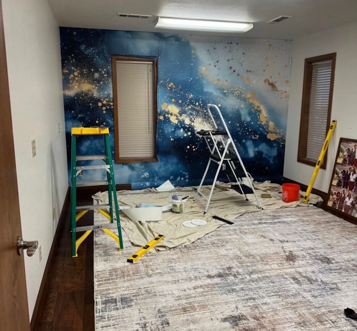 Indigo blue and gold abstract mural installed around a window