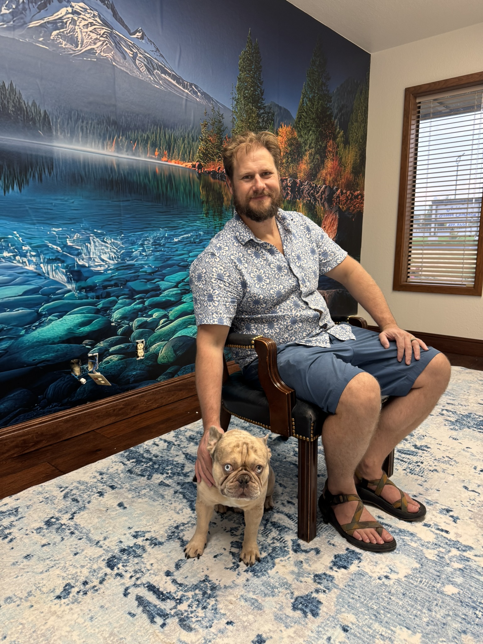 Close portrait of the client and dog beside the completed mountain mural